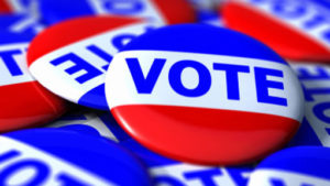 Close view of a collection of VOTE badges. 3D render with HDRI lighting and raytraced textures.