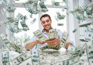 business, people, success and fortune concept - happy businessman with heap of dollar money at office